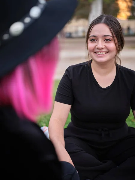 Woman sitting smiling and looking at her friend — 图库照片