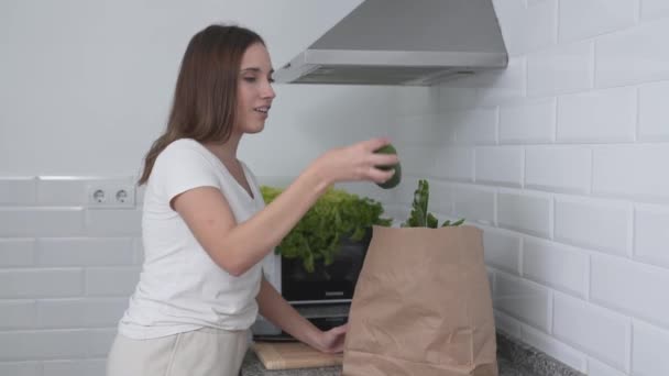 Woman With Grocery Bag Unpacks Fresh Green Vegetables. Medium Shot — Video Stock