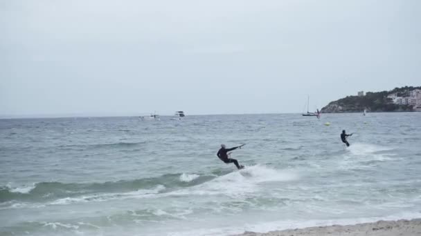 People Kitesurfing On The Beach On The Island of Mallorca - aerial drone shot — стоковое видео