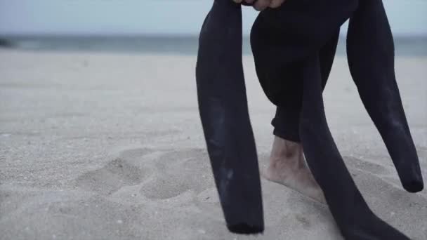 Cropped View Of A Man Wearing Wetsuit On Sandy Beach Of Mallorca Island In Spain. Closeup — Vídeo de Stock