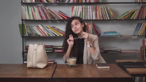 Woman With Coffee On Her Table Wear Her Eyeglasses Before Reading. Medium — Vídeo de Stock