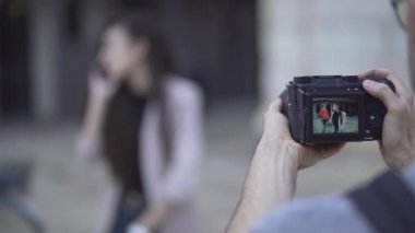 Female Model Talking In The Phone Posing At Photographers Camera - Stolen Shot Concept. - rack focus