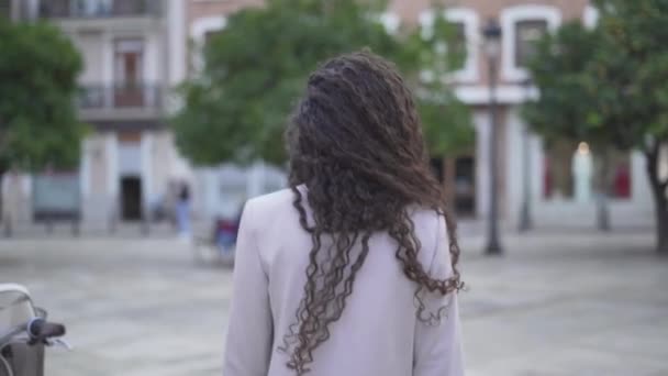 Back View Of Girl With Curly Long Hair Waling At The Park. - follow shot — Vídeo de Stock