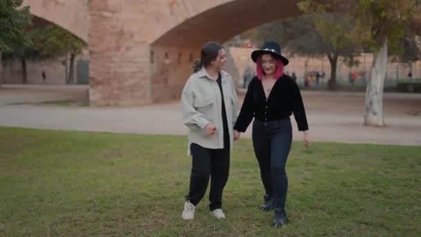 Cheerful girls dancing and having fun at leisure moment in park. Slowmotion — 图库视频影像