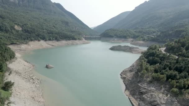 Drone sköt över Ayous sjön med vikande vattenstånd under höstsäsongen med frodig grön vegetation runt sjön i Pyrenéerna i Frankrike. — Stockvideo