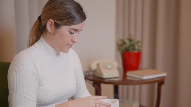 Self-employed woman entrepreneur checking production quality and packaging product in a cardboard box for delivery to the customer — Stock Video