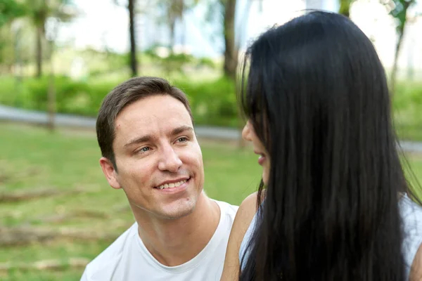 Man staring at his partner while sitting in a park — Stock Photo, Image