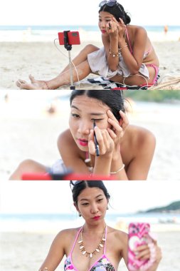 Asyalı kadın flama canlı yayın için makyaj yapıyor.