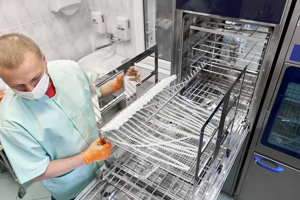 Top View Nurse Wearing Gloves Using Machine Sterilising Medical Supplies — Stok fotoğraf