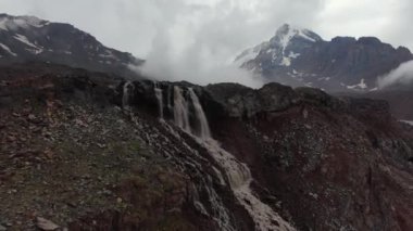 Drone shot of the glacier waterfall. Mount Kazbek. Stepantsminda (Kazbegi). Georgia. Camera track-in.