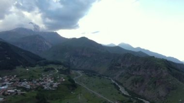 Stepantsminda (Kazbegi) and Gergeti. Aerial drone shot. 