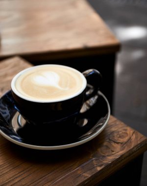Cup of coffee on wooden table in cafe Cappuccino or latte in mug. 