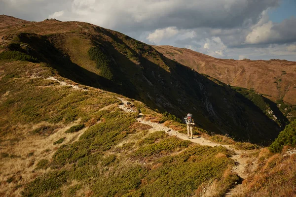 Mountain trail in Carpathian Mountains, Ukraine. Walking and hiking trails in Chornohora ridge. Rural area of carpathian mountains in autumn