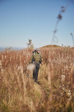 Man walking by mountain trail in Carpathian Mountains, Ukraine. Walking and hiking trails in Borzhava ridge. Rural area of carpathian mountains in autumn