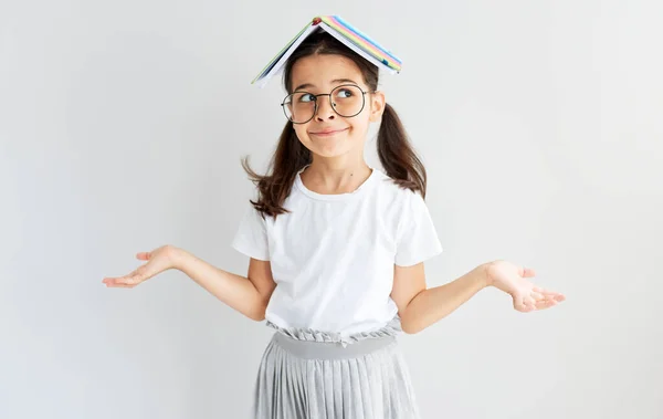 Studio Portrait Uncertain Little Girl Eyeglasses Book Head Roof Isolated Royalty Free Stock Images