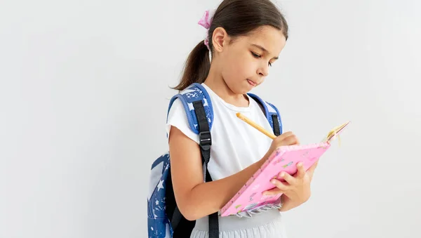 Cute Schoolgirl White Shirt Unifrom Blue Backpack Writes Something Her Stock Photo