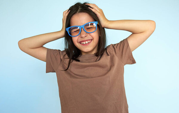 Overjoyed Caucasian Brunette Little Girl Wearing Brown Shirt Eyeglasses Reacts Stock Image