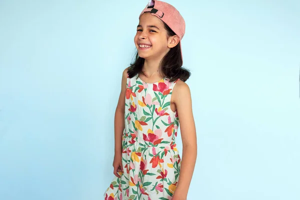 Joyful Kid Wearing Pink Colorful Dress Smiling Broadly Posing Studio lizenzfreie Stockbilder