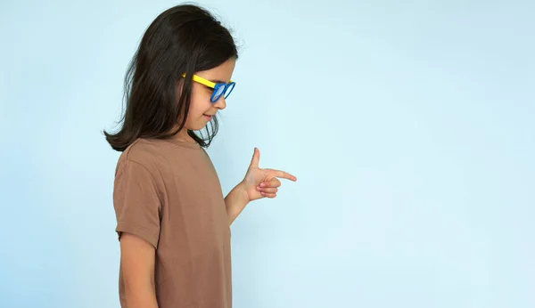 Side View Horizontal Image Little Girl Brown Shirt Blue Yellow lizenzfreie Stockbilder