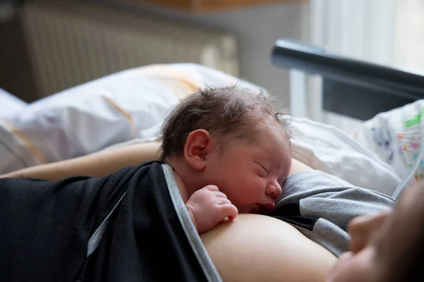 Newborn baby with mom after c-section Stock Picture