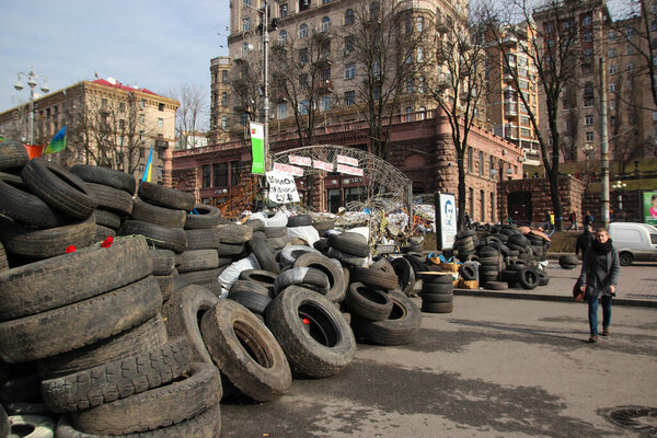Kyiv, Ukraine - 8th of March, 2014: City center with piles of pavement stones and tires not far from Maidan