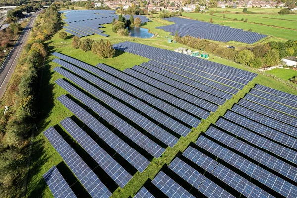 energy saving, global warming Solar energy farm. High angle, elevated view of solar panels energy farm rural England; full frame background texture
