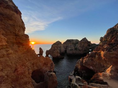 Praia Dona Ana Ponta da Piedade turkuaz deniz suyu ve uçurumları, Portekiz sahillerinde uçan martılar. Güzel Dona Ana Sahili (Praia Dona Ana) Lagos, Algarve, Portekiz.