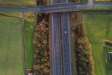 Morning sunrise highway motorway traffic. Aerial shot, top down view