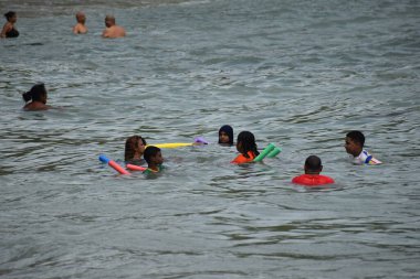 Toco, Trinidad ve Tobago- 28 Mart 2022 - Plaja gidenler, Karayipler 'in Trinidad adasının kuzey doğu kıyısındaki bir kıyı bölgesi olan Toco' daki Saline Bay 'de Sabah Sahil Banyosunun tadını çıkarıyorlar.
