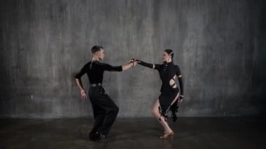 Genç, zarif bir kız ve erkek balo salonu çifti, siyah elbiseli, tango yapan, şehvetli bir şekilde dans ediyorlar. Profesyonel dansçılar Latin dansçıları canlandırır. İnsani duygular, aşk ve tutku