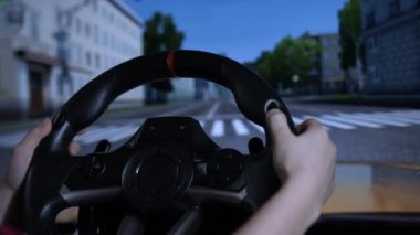 Schoolboy child driving simulator game on pc computer. Young boy using play station game with steering wheel. Kid playing car racing simulator on a video controller at home, learning to drive concept