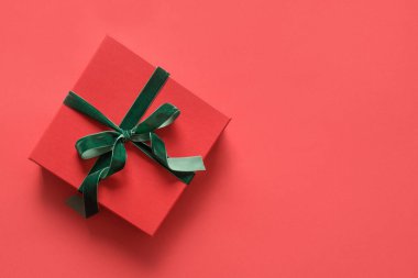 Kırmızı arka planda kırmızı Noel hediyesi. Xmas tebrik kartı.