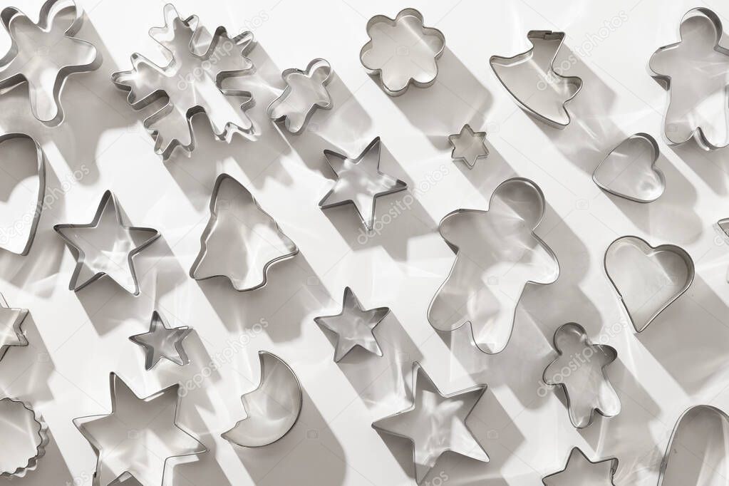 Christmas-themed cookie cutters as pattern. Xmas background.
