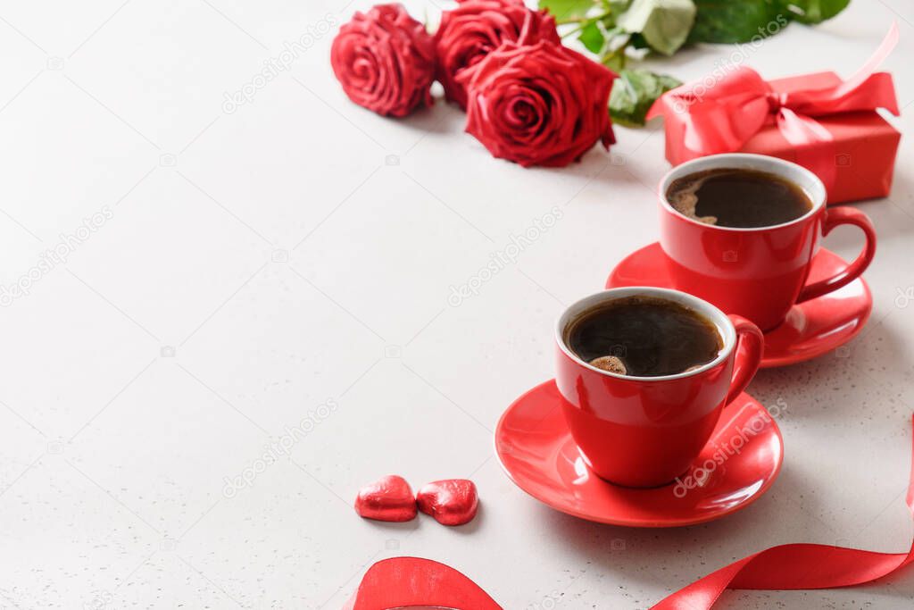 Valentine's day dating with coffee, red chocolate sweets and roses on white background. Close up. Romantic date for two.