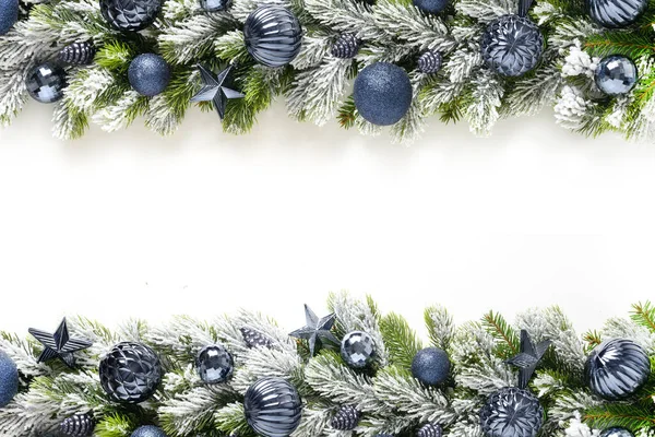 Різдвяна рамка з блакитними вафлями і зірками в ряд на засніжених вічнозелених гілках . — стокове фото