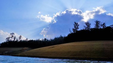 Pykara Gölü, Ooty, Tamilnadu 'nun güzel manzarası. Gökyüzünün muhteşem manzarası, su ve tekne yolculuğundan görülebilen yeşil çalılar. Güney Hindistan 'daki en iyi balayı yeri..