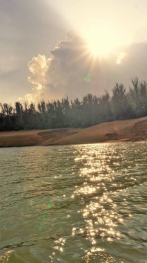 Günbatımında Pykara Gölü, Ooty, Tamilnadu 'nun güzel manzarası. Gökyüzü manzarası, su, gün batımı ve tekne yolculuğundan görülebilen yeşil çalılar. Güney Hindistan 'daki en iyi balayı yeri..