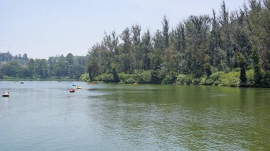 Ooty,Tamilnadu,India-April 30 2022: Boating in ooty lake. Artificial lake in the Nilgiris district of Tamil Nadu, India. Major scenic tourist attraction with Paddle, Row and Motor boats.