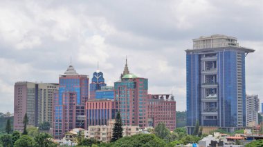 Bangalore,Karnataka,India-June 19 2022: View of Bangalore cityscape from terrace of Chancery Pavilion Hotel. Stadium and skyscrapers such as Prestige UB City Concorde Block visible through green cover.