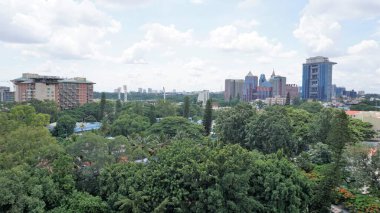 Bangalore,Karnataka,India-June 19 2022: View of Bangalore cityscape from terrace of Chancery Pavilion Hotel. Stadium and skyscrapers such as Prestige UB City Concorde Block visible through green cover.
