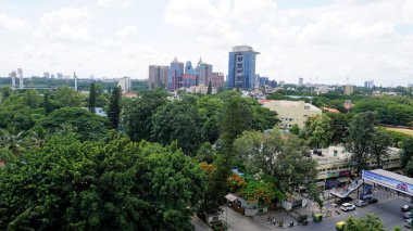 Bangalore,Karnataka,India-June 19 2022: View of Bangalore cityscape from terrace of Chancery Pavilion Hotel with busy road of Bangalore city. Stadium and skyscrapers such as Prestige UB City Concorde Block visible through green cover along with city 
