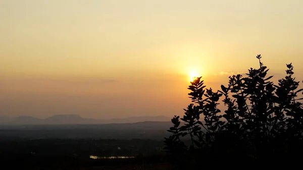 植物や茂みの背景の後ろに夕日の風景写真 バンガロール近くの山頂からの景色 — ストック写真
