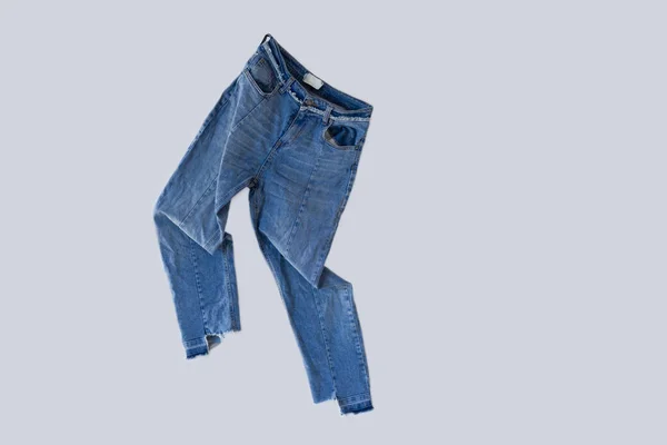 Fuja Jeans Rasgados Isolados Pendurados Parede Branca Jeans Desgastados Voando — Fotografia de Stock
