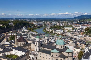 Salzburg City, Land Salzburg, Avusturya 'daki ünlü Tarih Merkezi (Altstadt) ve Salzach Nehri' nin antik kiliseleriyle şehrin yüksek açılı manzarası. Güneşli bir gün, mavi gökyüzü, bulutlar. Avusturya tarihi eserleri. Turistik bir yer. 
