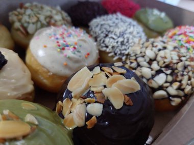 Çikolatalı donutlar, pembe jöleli ve şekerli çörekler.