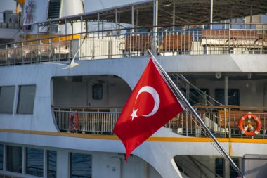 Turkish flag in the foreground and istanbul ferry in the background