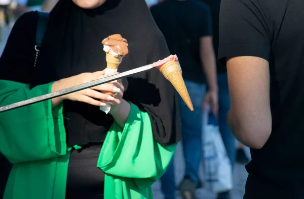 Turkish ice cream vendor jokes and customers having fun. Traditional turkish ice cream sales.
