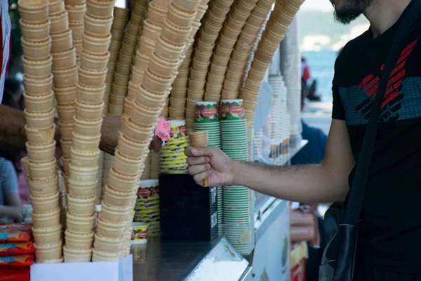 Turkish ice cream vendor jokes and customers having fun. Traditional turkish ice cream sales.