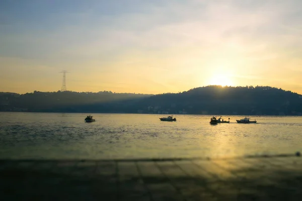 Men on a boat in Bosphorus waters in Istanbul. Fisherman in boat in Istanbul. Turkish fisherman sailing in boat in sea.