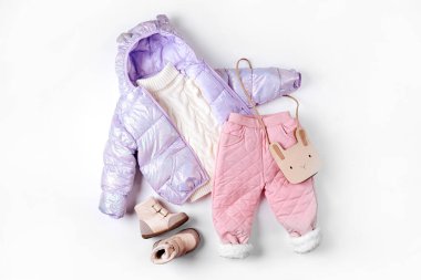 Puffer jacket, warm pants and boots on white background. Set of baby clothes for winter. Fashion kids outfit.	